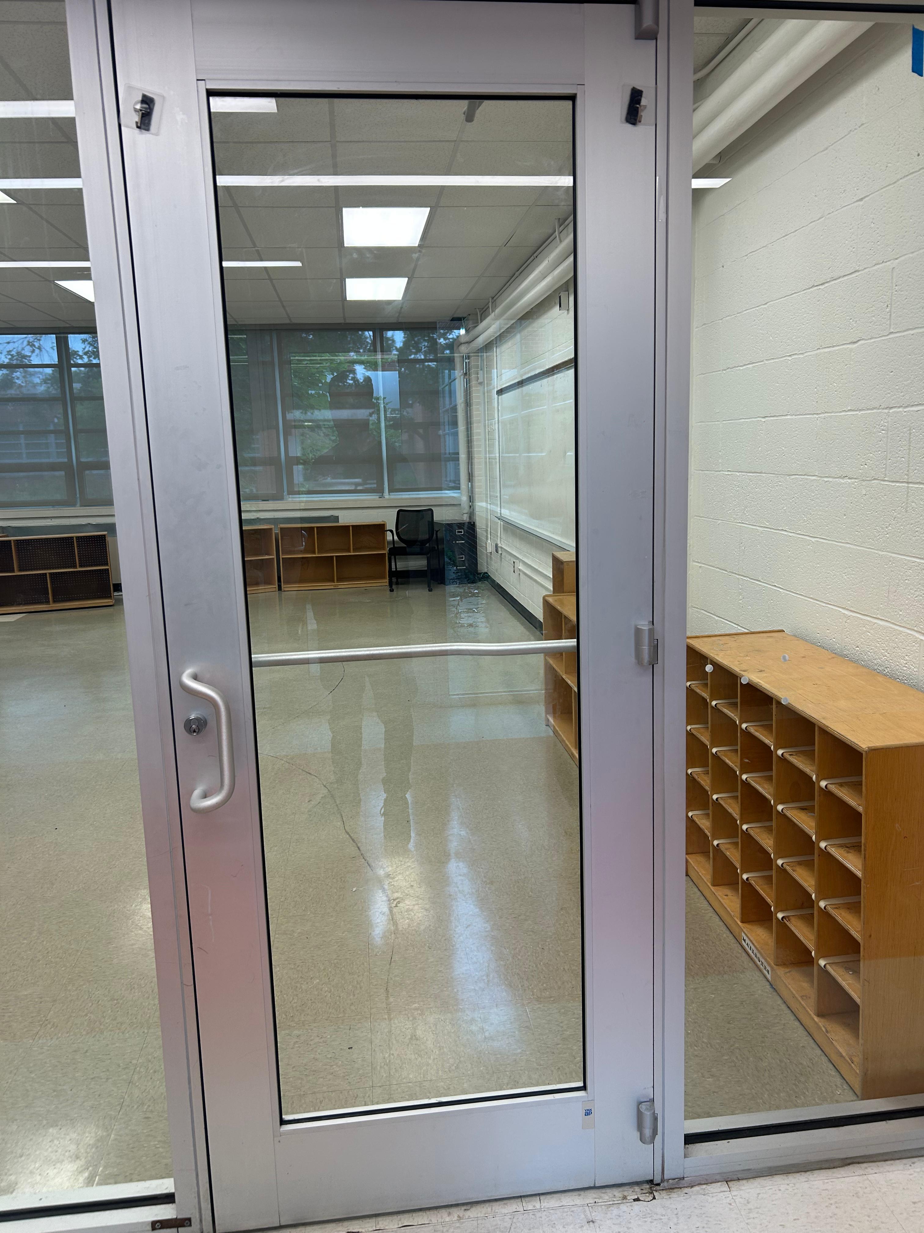 Full glass office door installation at a school facility
